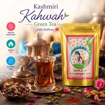 A gold stand-up pouch of World of Chai Kashmiri Kahwah Green Tea with Saffron next to a glass teacup filled with amber tea, set on a rustic table with almonds, rose petals, and decorative teapot in the background.